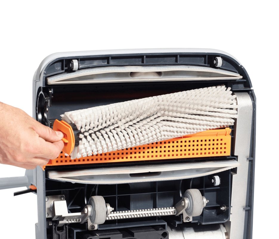 Hand replacing the brush on a Nilfisk SC100 floor cleaning machine